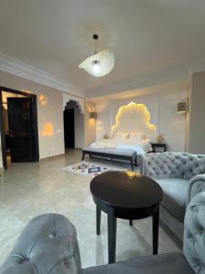a bedroom with a bed and a couch and a table at Royal Moroccan House in Marrakesh +38 photos