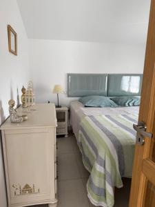 a bedroom with a bed and a night stand next to it at St Cyprien beau T3 entre mer et village in Saint-Cyprien