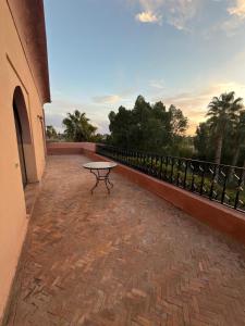 a patio with a table on the side of a building at Royal Moroccan House in Marrakesh