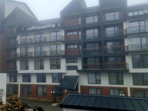 an apartment building with balconies on the side of it at RELAX RESIDENS-kopaonik in Kopaonik