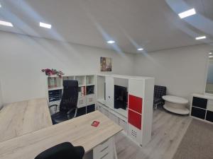 a large room with a desk and a table at Haltijanmetsä in Kotka