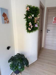 a hallway with a wreath of flowers on a wall at Pisano Suite in Agrigento