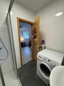 a laundry room with a washing machine in a bathroom at Apartment in Rimpar in Rimpar