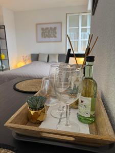 a tray with wine glasses and a bottle on a table at Apartment in Rimpar in Rimpar