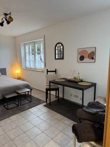 a bedroom with a desk and a bed and a table at Apartment in Rimpar in Rimpar