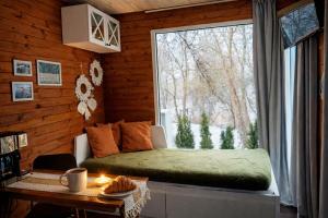 a room with a bed and a large window at Wisla66 Domki nad Wisłą Piotrawin in Piotrawin