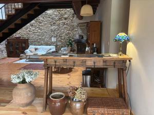 a living room with a table and some plants at Golindo Goikoa in Getaria +27 photos