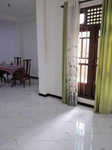 a dining room with a table and a window at Home stray 7 in Matara