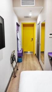 a room with yellow and purple doors and wooden floors at City Hotel Shymkent in Shymkent +53 photos