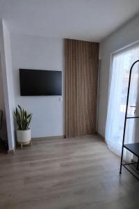 a living room with a flat screen tv on a wall at Studio Coeur Basque in Iholdy