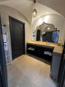 a bathroom with a sink and a large mirror at Royal Moroccan House in Marrakesh
