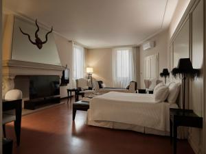 a hotel room with a bed and a fireplace at Santa Maria Foris in Ravenna