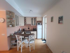 a kitchen with a table and chairs in a room at Jõekalda kodu in Pärnu