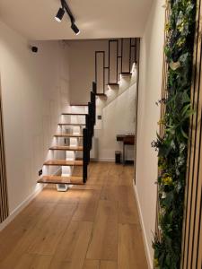 a hallway with stairs and a table in a room at RotHaus Old Town Sibiu in Sibiu