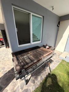 a bench in front of a window on a house at 20 minutes from Chapala, Pool &Grill in Buenavista