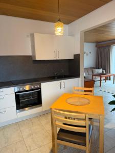 a kitchen with a table and a dining room at Hotel Garni Sebastian in Kirrweiler +11 photos