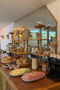 a kitchen with plates of food on a counter at Hotel Garni Sebastian in Kirrweiler