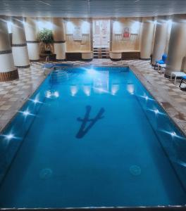 a swimming pool with a person in the water at The Heritage Hotel in Torquay