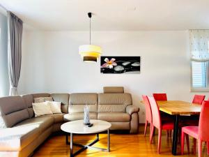 a living room with a couch and a table at Apartments KIDS in Kaštela
