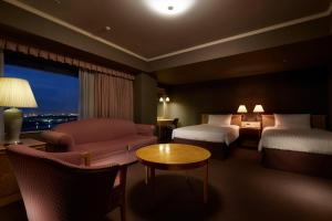 Rúm í herbergi á Hotel Agora Regency Osaka Sakai