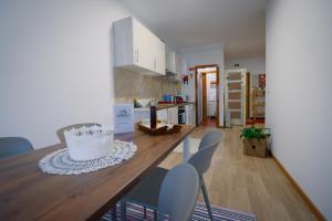a kitchen with a table and chairs in a room at Alojamento da Zá in Vila Pouca de Aguiar +19 photos