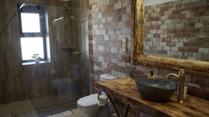 a bathroom with a sink and a toilet and a mirror at Lomb Lak Vendégház in Kozármisleny +57 photos