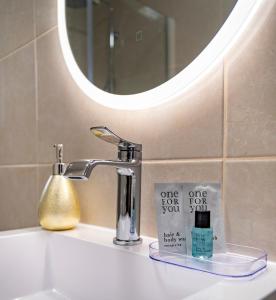 a bathroom sink with a faucet and a mirror at House Mila in Korenica +70 photos