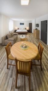 a living room with a table and chairs and a couch at House Mila in Korenica