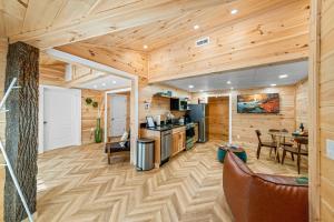 a kitchen and living room in a log cabin at Hickory Hideaway Dollywood, Island, LeConte in Pigeon Forge