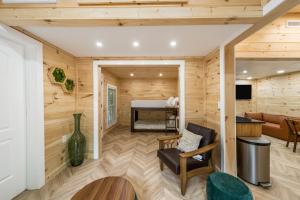 a living room with wood paneled walls and a fireplace at Hickory Hideaway Dollywood, Island, LeConte in Pigeon Forge