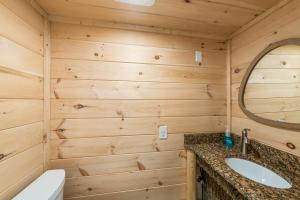 a bathroom with a sink and a mirror at Hickory Hideaway Dollywood, Island, LeConte in Pigeon Forge +24 photos