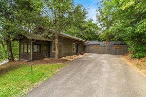 a house with a garage and a driveway at Hickory Hideaway Dollywood, Island, LeConte in Pigeon Forge
