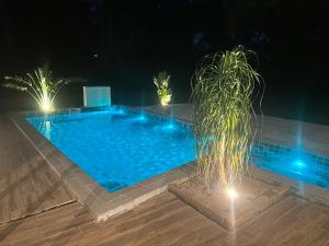 a swimming pool at night with lights at Casa en Sanber in San Bernardino