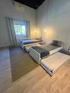 a bedroom with two beds and a window at Casa en Sanber in San Bernardino