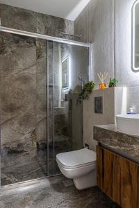 a bathroom with a shower and a toilet and a sink at Point Zero Xanthi in Xanthi