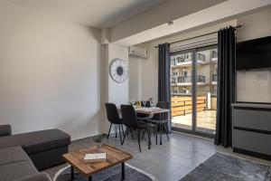 a living room with a couch and a table at Point Zero Xanthi in Xanthi +18 photos