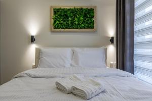 a bedroom with a bed with two towels on it at Point Zero Xanthi in Xanthi