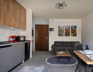 a kitchen and living room with a couch and a table at Point Zero Xanthi in Xanthi