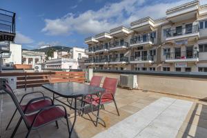 a table and chairs on a balcony with a building at Point Zero Xanthi in Xanthi