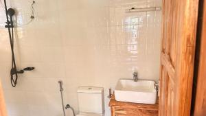a bathroom with a sink and a toilet at Two rivers lodge in Arusha