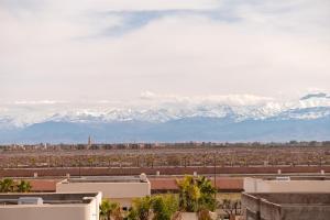 a view of snow covered mountains in the distance at Villa Soliya 4 Rooms with private pool in Marrakesh