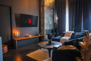 a living room with a couch and a table at Suite 202 in Mâcon