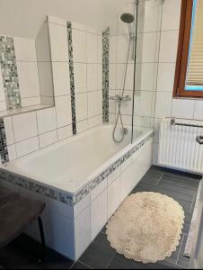 a bath tub in a bathroom with a rug at Molers in Stühlingen +10 photos