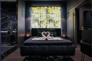 a bedroom with a bed with a large window at Suite 202 in Mâcon
