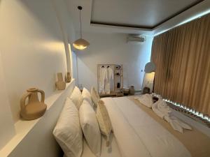 a white bed with pillows on it in a room at Uma Danu Villas Kintamani in Kubupenlokan