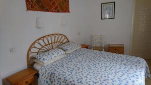 a bedroom with a blue and white bed with two pillows at Cedra 5, Holiday home, cosy apartment in Turre +54 photos