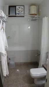 a white bathroom with a toilet and a sink at Hotel Aravali Hills View in Kuchāman City +10 photos