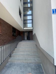 an empty hallway of a building with stairs at Studio7 center apartment Prizren in Prizren +4 photos