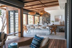 a living room with a couch and a table at La Pépite Villa in Pointe d'Esny +19 photos