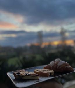 a plate with bread and cookies on a table at B&BPodere1149 in Villafranca